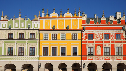View of colorful buildings in the historic Great Market Square at Zamosc, Poland. Photo taken on a sunny winter day.