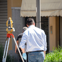 topographic survey in the city carried out by an engineer with theodolite or total positioning station