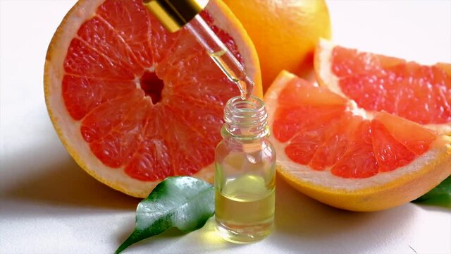 Grapefruit essential oil in a small bottle. Selective focus.