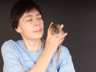 studio portrait of woman with brown rat