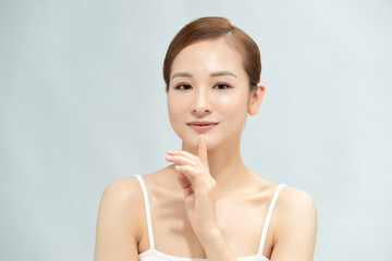 Beautiful Young Asian Woman with Clean Fresh Skin is touching her face, Facial treatment, Cosmetology, beauty and spa,