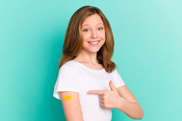 Photo portrait girl got vaccine from covid-19 smiling pointing finger recommending isolated vibrant...