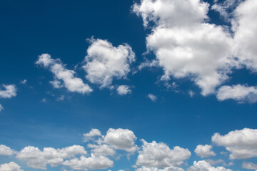 Fototapeta na wymiar White fluffy clouds against a blue summer sky