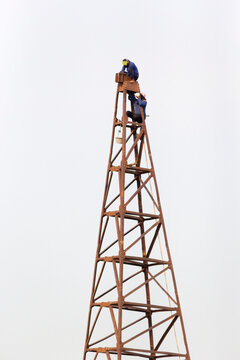 Workers assembling pile driving machines