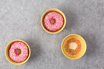 Sweet donuts with fondant close-up, top view