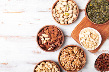 Different kind of nuts in wooden bowls