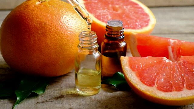Grapefruit essential oil in a small bottle. Selective focus.