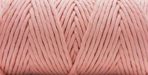 Close-up view of the single strand pink cotton cords for macrame DIY handcraft.