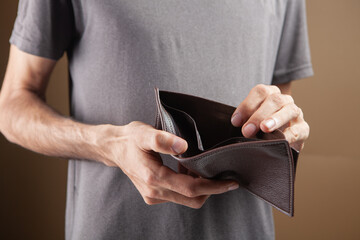 man showing empty wallet