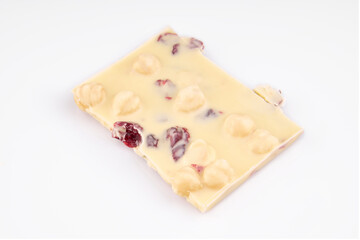 Macro photo of Chocolate bar. Broken pieces over white background. Milk chocolate pieces isolated on white background
