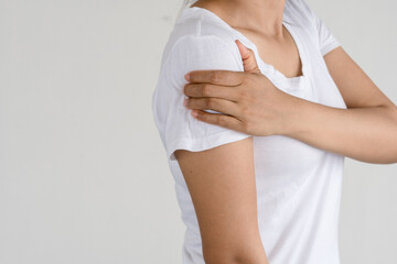 Asian woman with pain in shoulder. Pain in the human body,health care concept.