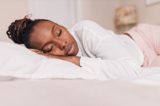 Young Black Woman Sleeping On Comfy Bed At Home