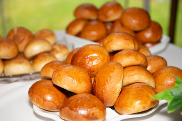 Plates with bread buns on a table