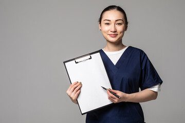 Medical doctor woman showing sign clipboard with copy space for text or design. Female medical...