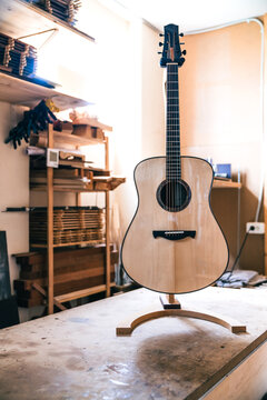Acoustic guitars against manual instruments in workshop