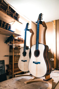 Acoustic guitars against manual instruments in workshop