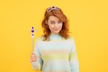 redhead woman in crown. queen with magic wand. selfish princess in tiara. woman hold magic stick.