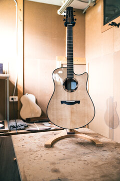 Acoustic guitars against manual instruments in workshop