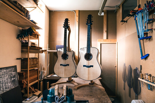 Acoustic guitars against manual instruments in workshop