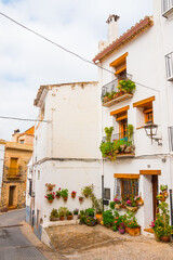 Fototapeta na wymiar Jérica, Alto Palancia, Castellon province, Valencian Community, Spain. Beautiful typical spanish street and houses. Historic city center. Whitewashed building.