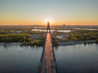 North bridge in Kiev. Rising sun rays along the bridge. Sunrise through the pylon. Aerial drone...