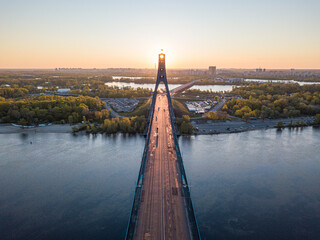 North bridge in Kiev. Rising sun rays along the bridge. Sunrise through the pylon. Aerial drone...