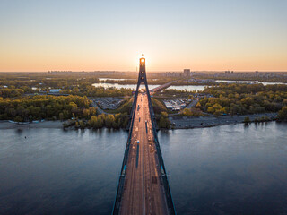 North bridge in Kiev. Rising sun rays along the bridge. Sunrise through the pylon. Aerial drone...