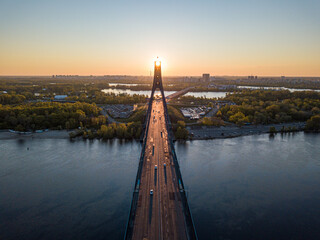 North bridge in Kiev. Rising sun rays along the bridge. Sunrise through the pylon. Aerial drone...