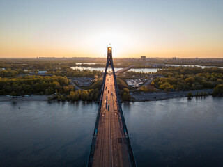 North bridge in Kiev. Rising sun rays along the bridge. Sunrise through the pylon. Aerial drone...