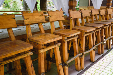 row of high wooden chairs, bar counter.