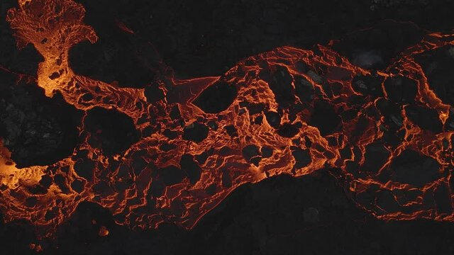 Aerial top-down over golden lava abstract texture. Drone static view