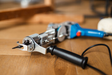 Photo of sewing machine on wooden floor indoors