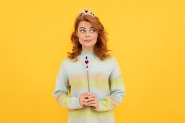 redhead woman in queen crown with magic wand, wish