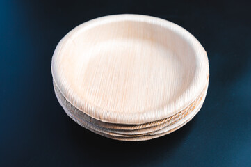 dried palm leaf or betel nut and leaf dish plate disposable tableware product, zero waste environment concept, Natural eco-friendly organic food packaging on black background.