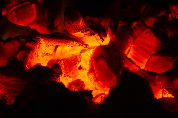 hot coals shine brightly in the dark