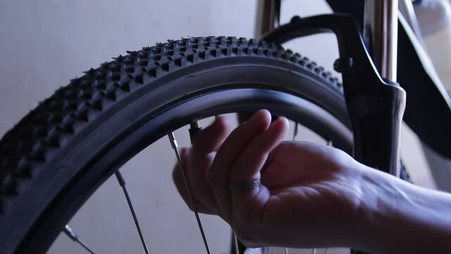 Man inflates a bicycle wheel