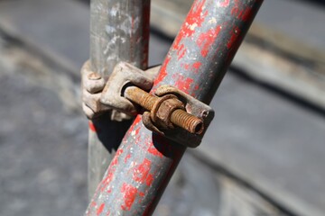 A close up view of a metal joint on a piece of scaffolding pipe.