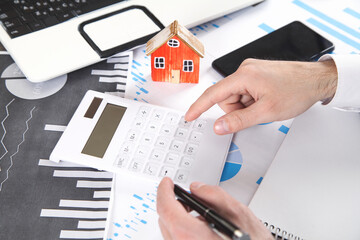 Man calculating house loan of finance and investment for real estate.