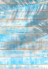 ビンテージ感のある青いウッドデッキと、椰子の葉陰
