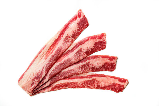 Raw beef bacon isolated on white background. Pieces of marbled beef bacon.