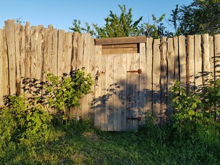 Gate in an old wooden fence