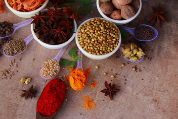 Colorful herbs and spices for cooking,Indian spices,indian spices on wooden table,indian cuisine. Top view flat lay,Indian bay leaf, Garam masala, Mace, Javitri, Nutmeg, Jaiphal, Star Anise,