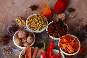 Colorful herbs and spices for cooking,Indian spices,indian spices on wooden table,indian cuisine. Top view flat lay,Indian bay leaf, Garam masala, Mace, Javitri, Nutmeg, Jaiphal, Star Anise, - obrazy, fototapety, plakaty