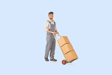 Delivery man with hand truck and transporter style brown cardboard box.