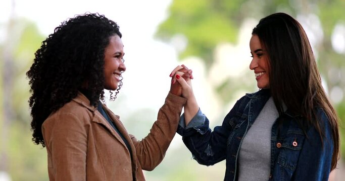 Two Diverse Young Women Joining Hands In Unity, Black And White Girls Uniting Hand Together, Diversity Concept