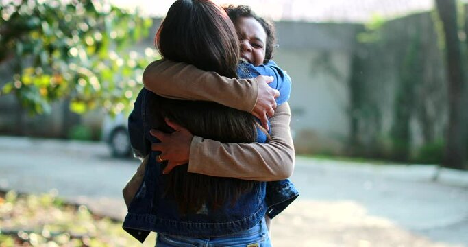 Two female friends hug and embrace outside, real life happiness reunion