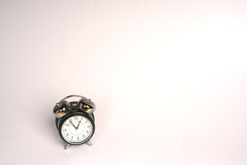 Black and white analog alarm clock on a white background. Retro style. Space for text