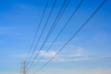 Fototapeta premium Electric poles and lines at dusk or high voltage towers at beautiful sky