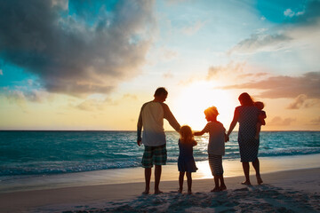 happy family with kids walk at sunset beach - 437050825