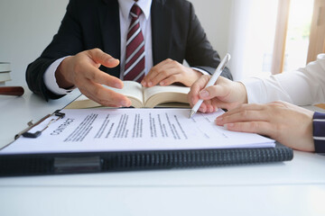 Partner lawyers or attorneys discussing a contract agreement. Successful businessmen hand putting signing contract,have a contract in place to protect it,signing of modest agreements form in office.